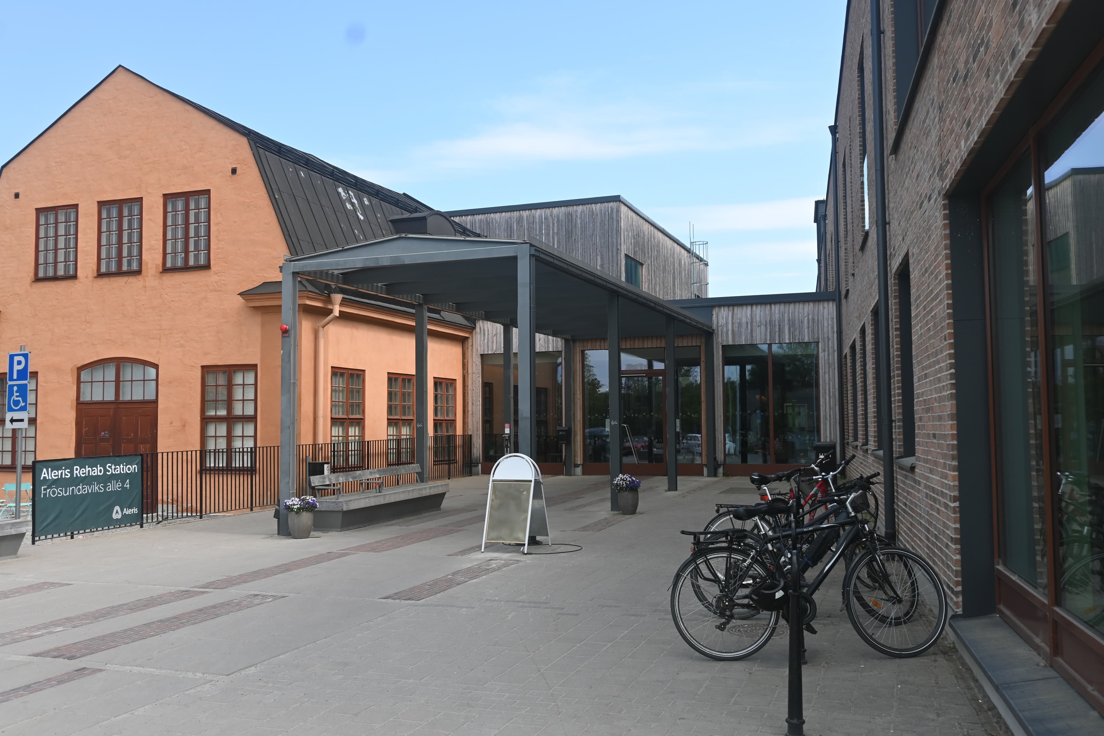 Några cyklar står parkerade framför en byggnad.