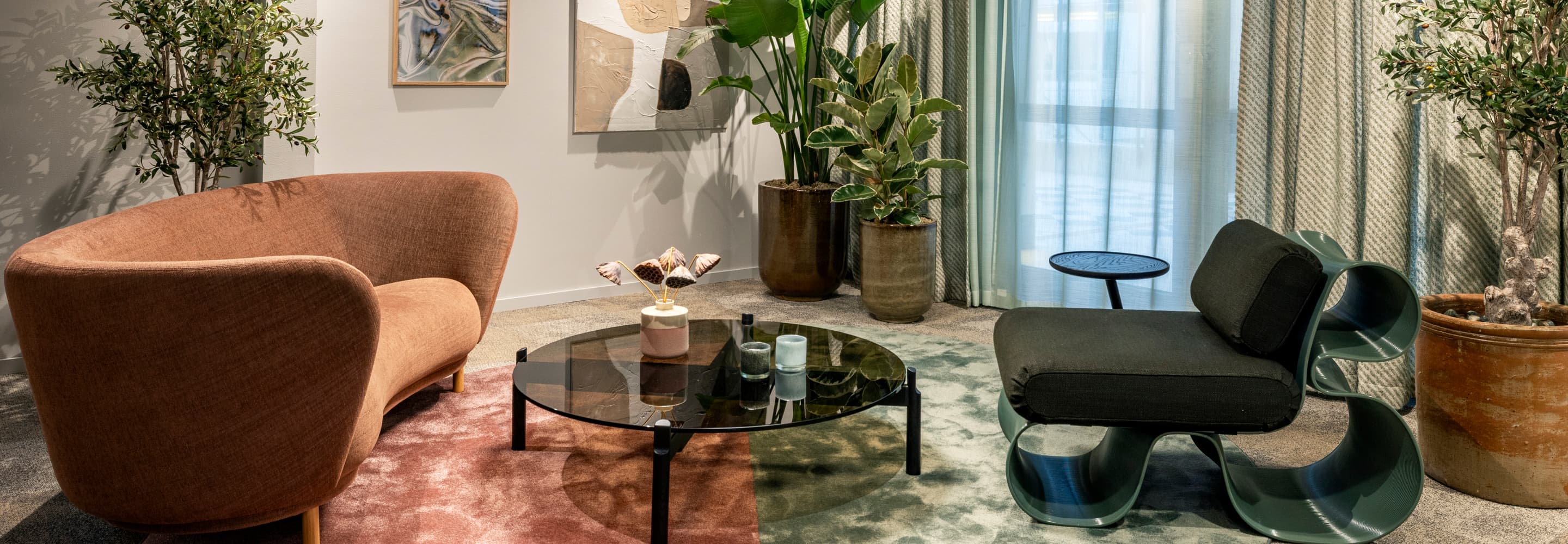 Ett vardagsrum fyllt med möbler och växter.