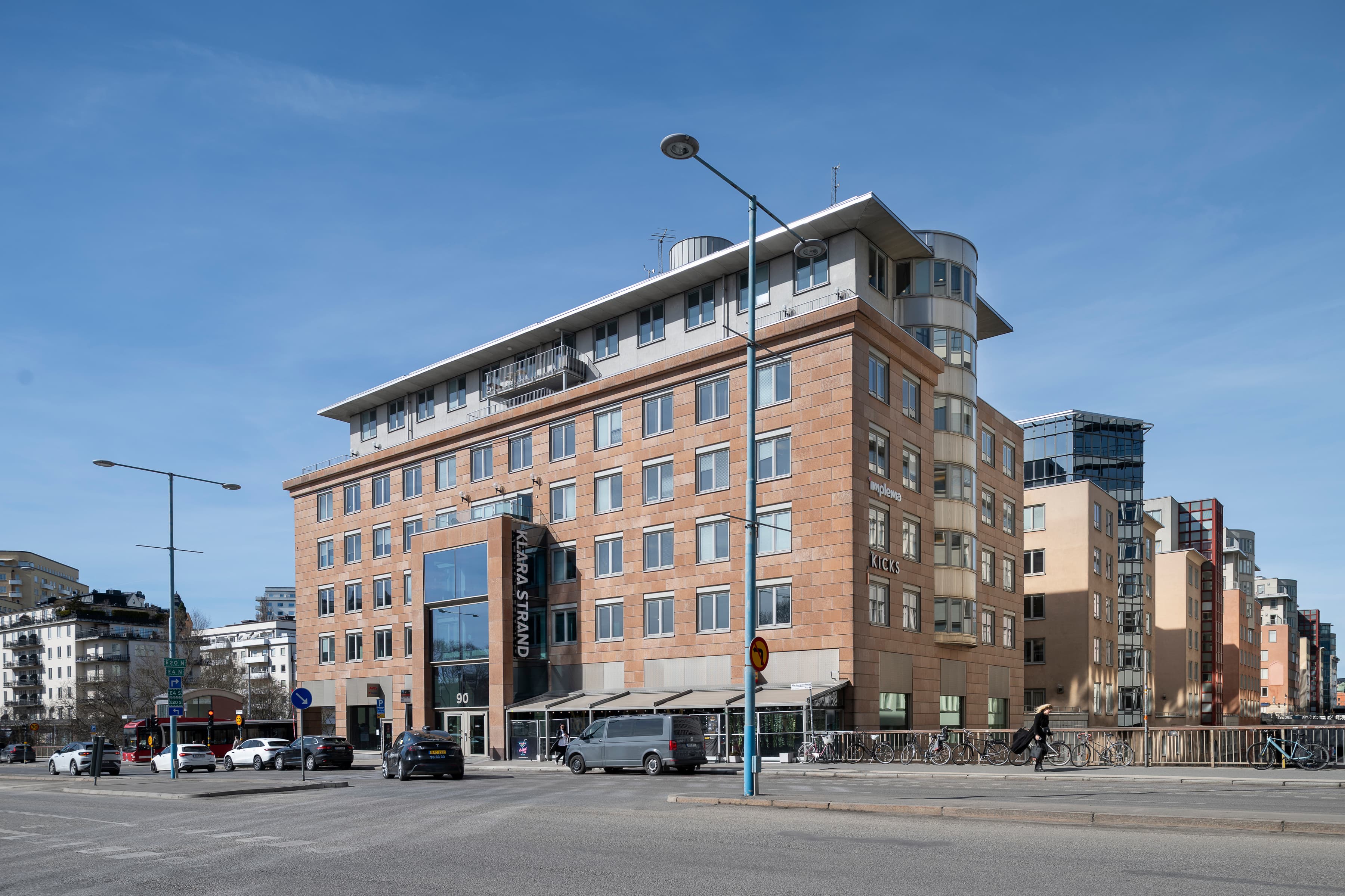 En stor tegelbyggnad som ligger vid sidan av en väg.