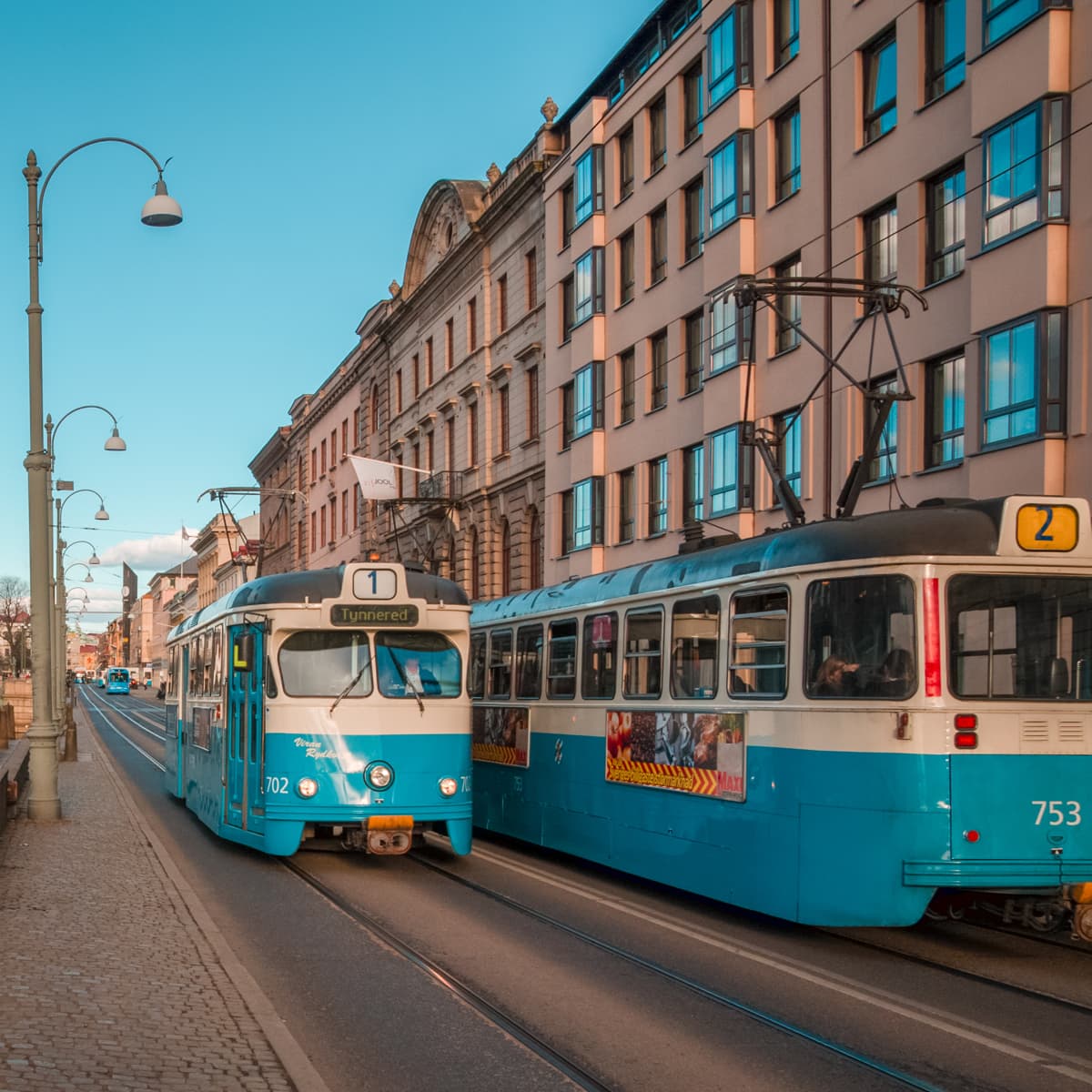 Några bussar som står på en gata.
