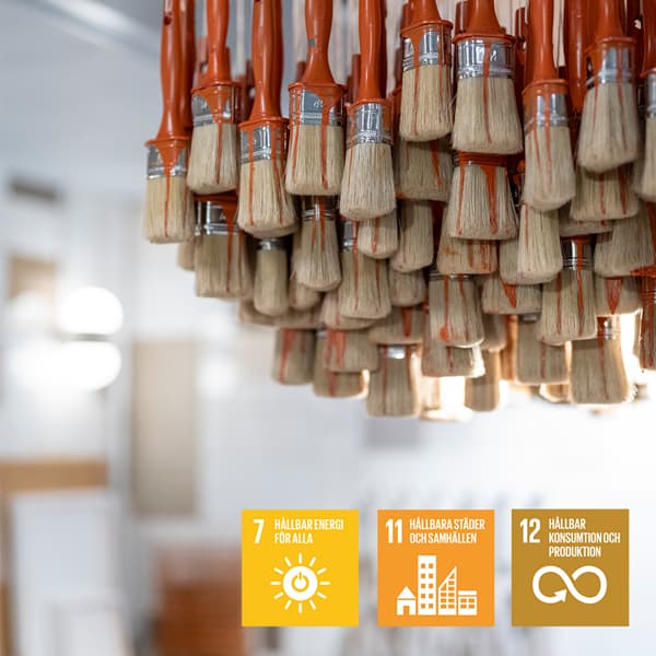 Ett gäng penslar som hänger från en kristallkrona.