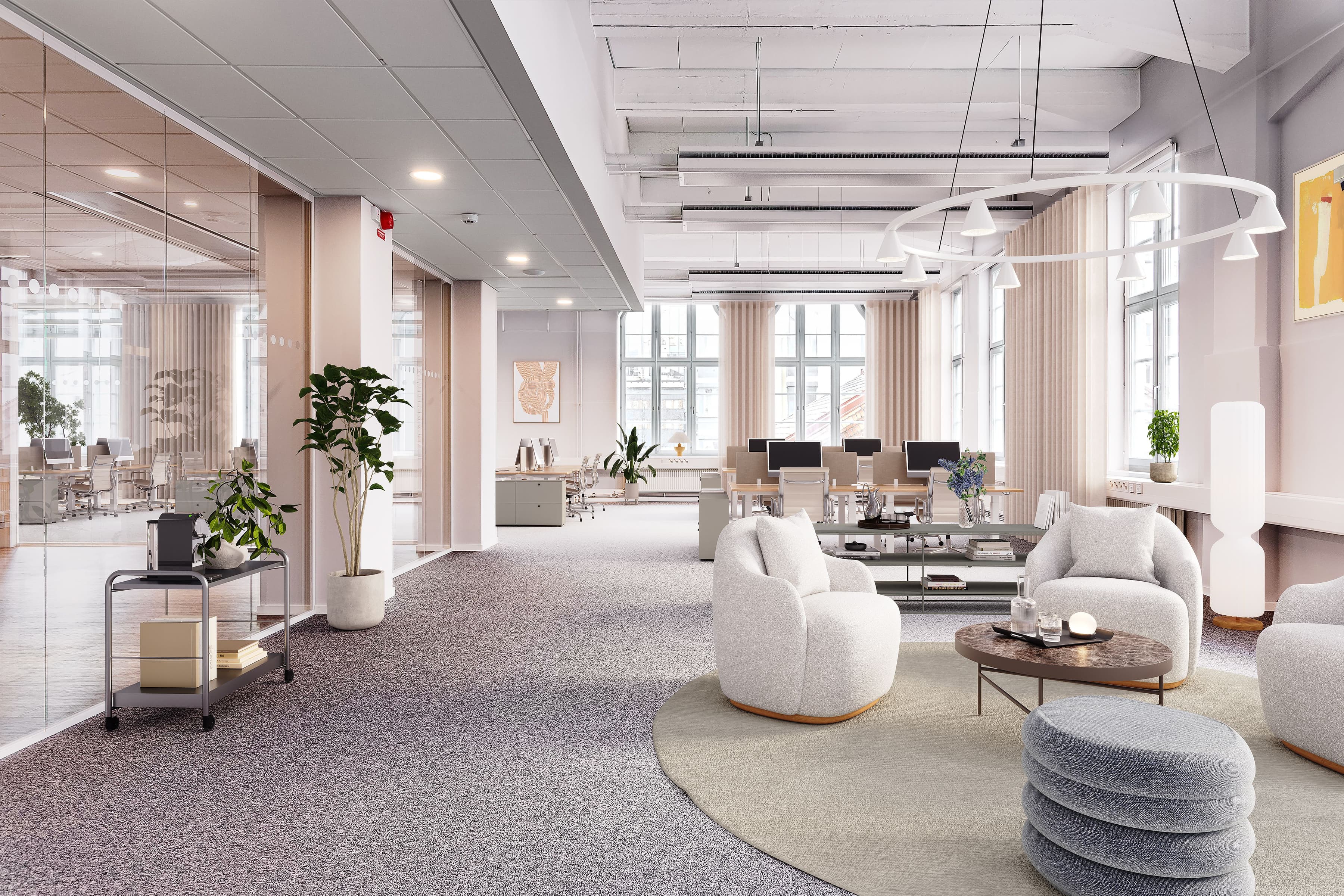 Ett stort öppet kontor med vita möbler och stora fönster.